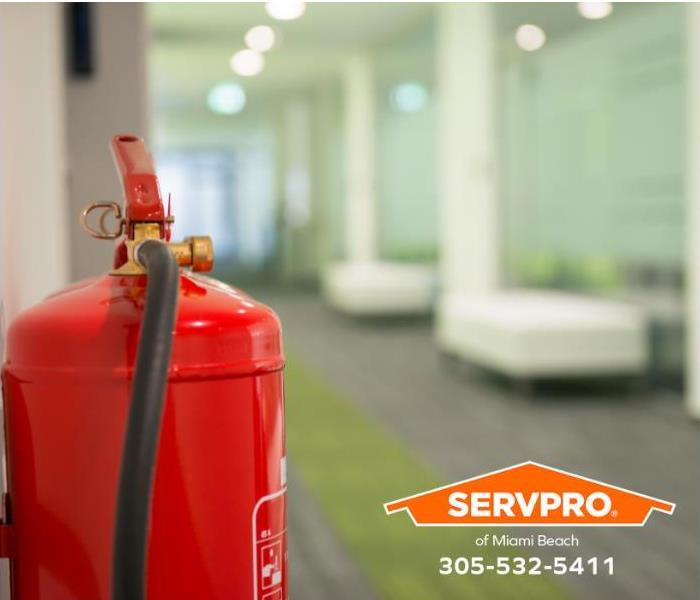 A fire extinguisher is installed in an office hallway.