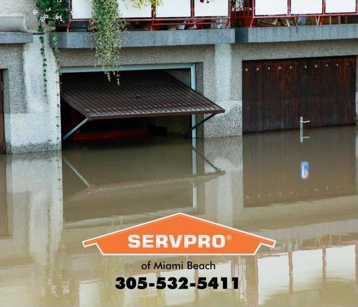 Residential parking garages located below street level are shown flooded. 