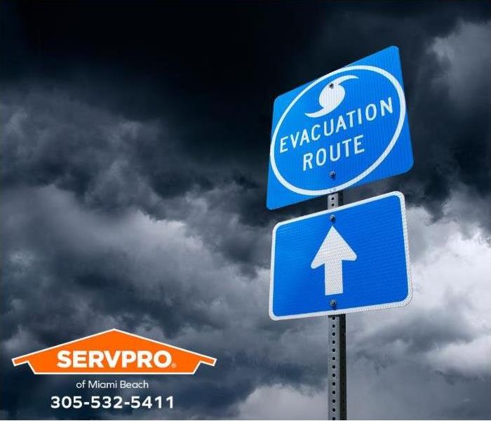 A hurricane evacuation route sign is shown.