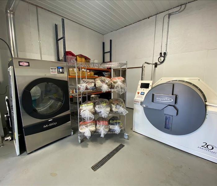 [TEXT] Our ESPORTA washing system cleans THAT. ESPORTA  grey and black rounded cleaning machine. Orange and grey background 
