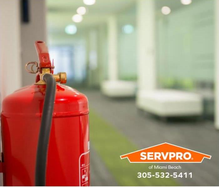 A fire extinguisher is installed in an office hallway.